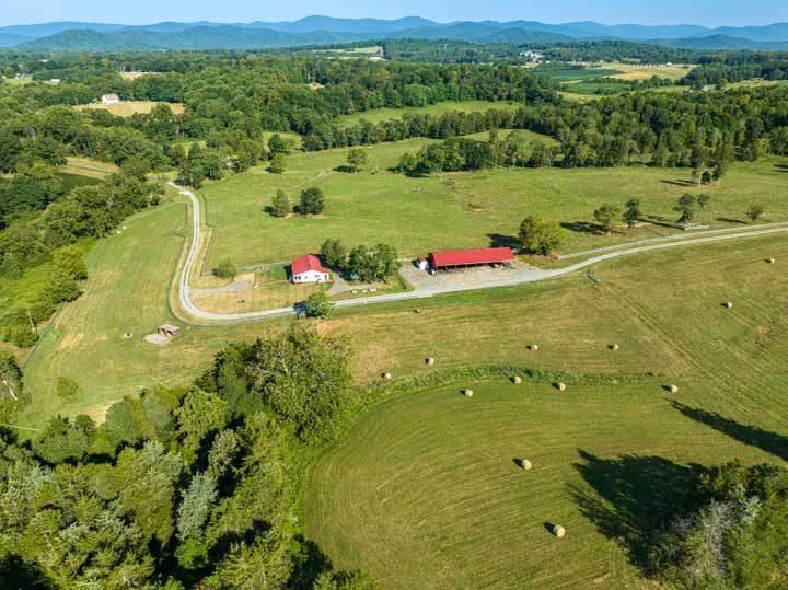 Aerial view of pasture, hay bales and farm buildings