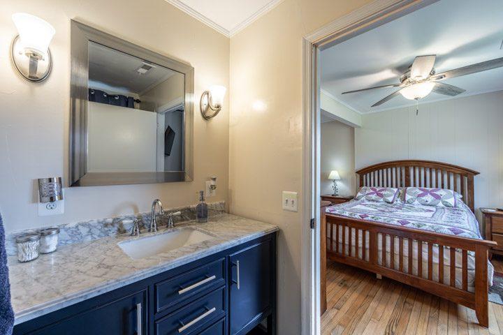 Bathroom vanity with a bedroom beyond