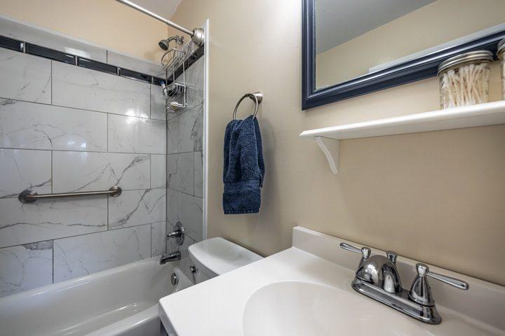 Bathroom with a tiled tub and shower