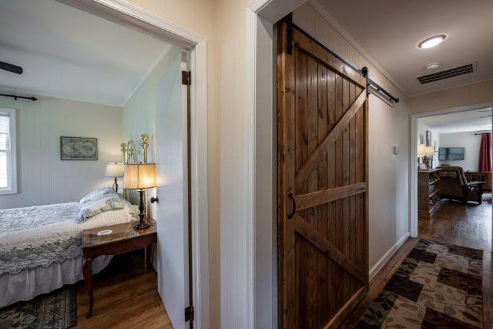 Bedroom beside a wooden barn door