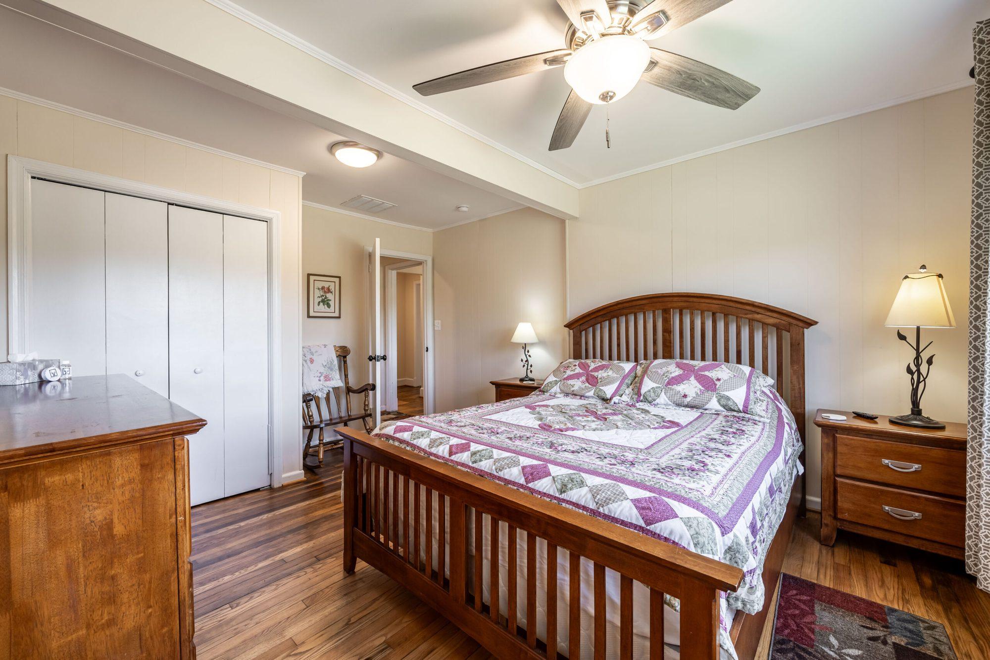 Bedroom with a wooden bed and a large closet