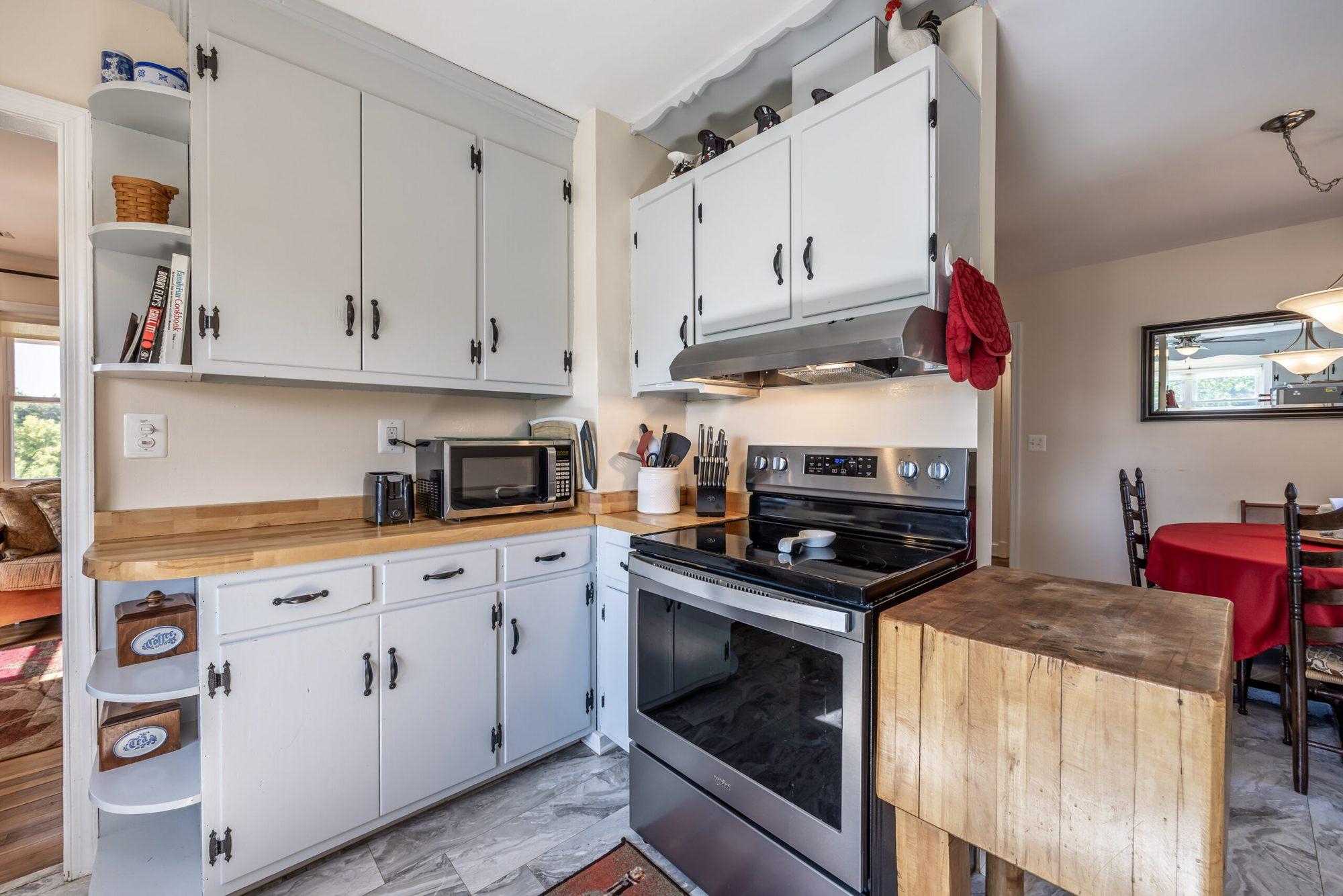 Kitchen cabinets and countertop with a view toward the dining area