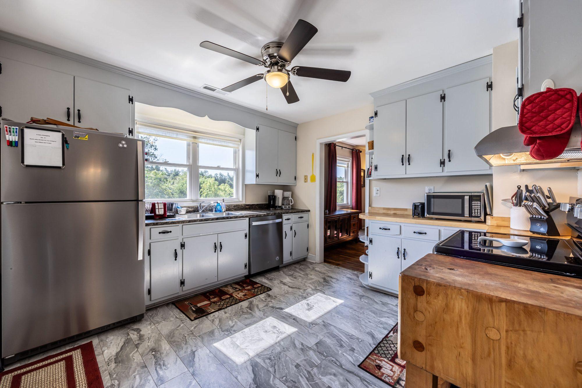 Kitchen with a stainless steel refrigerator and window over the sink