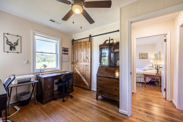 Desk area with a barn door and views of the fields