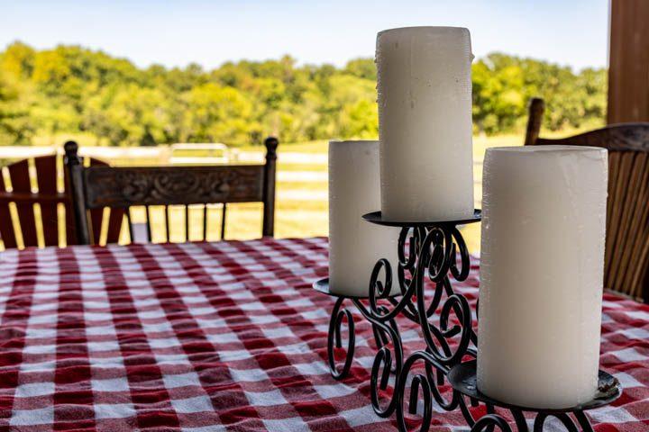 Checkered tablecloth and candles on the pavilion table