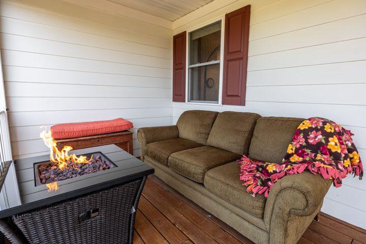 Porch seating with a sofa and a gas fire table