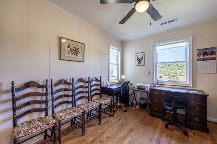 Sitting area with ladder-back chairs and a desk