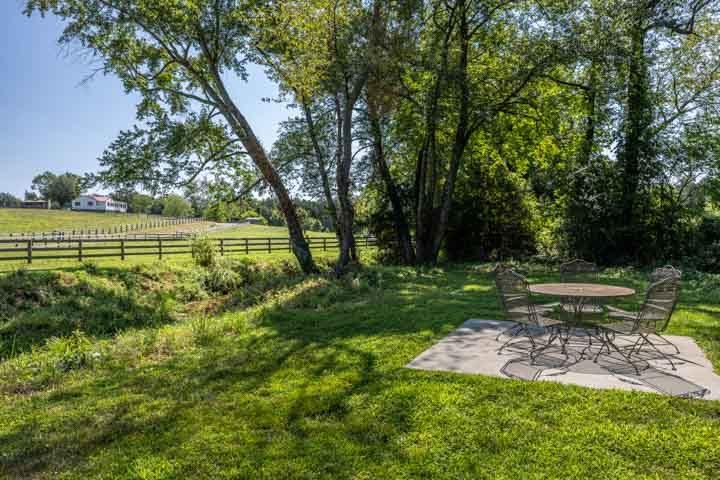 Patio table and chairs beside the stream